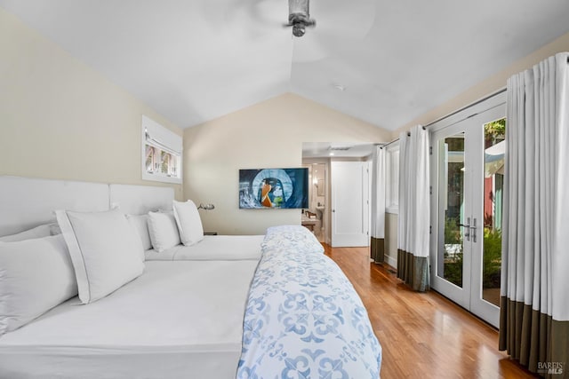 bedroom featuring a ceiling fan, vaulted ceiling, french doors, access to outside, and wood finished floors
