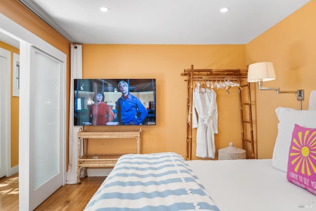 bedroom featuring recessed lighting and wood finished floors