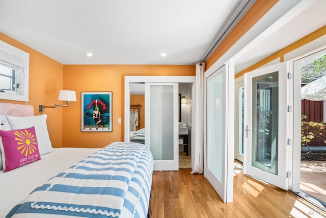 bedroom with french doors, wood finished floors, access to exterior, and recessed lighting