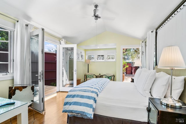 bedroom featuring lofted ceiling, french doors, ceiling fan, wood finished floors, and access to exterior