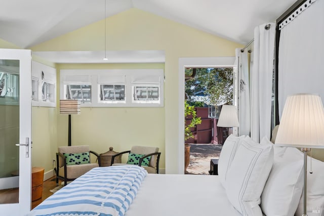 bedroom with wood finished floors and vaulted ceiling
