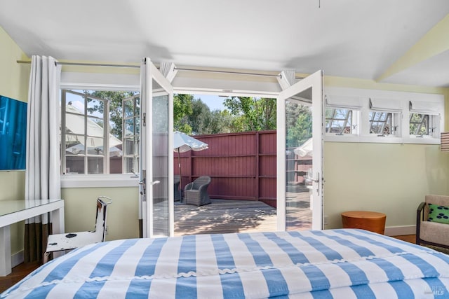 bedroom featuring french doors and wood finished floors