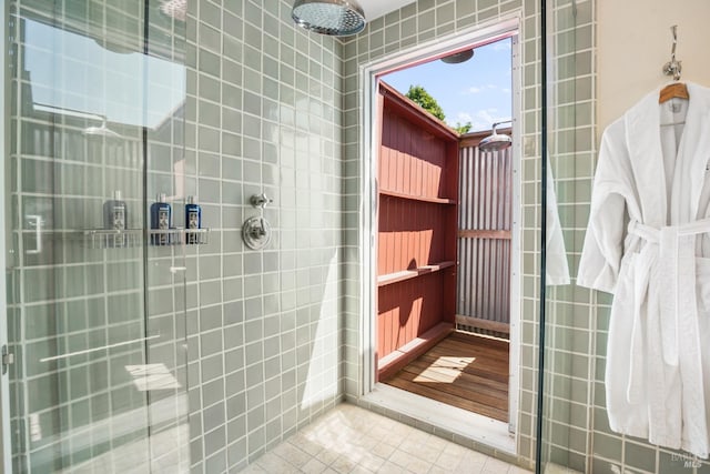 bathroom featuring tiled shower and tile patterned floors