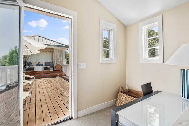 entryway with vaulted ceiling and baseboards