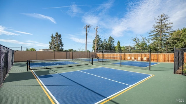 view of sport court featuring fence