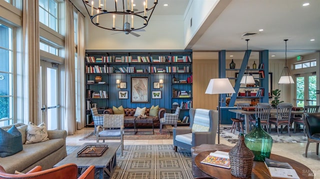 living area featuring a chandelier, a high ceiling, visible vents, and recessed lighting