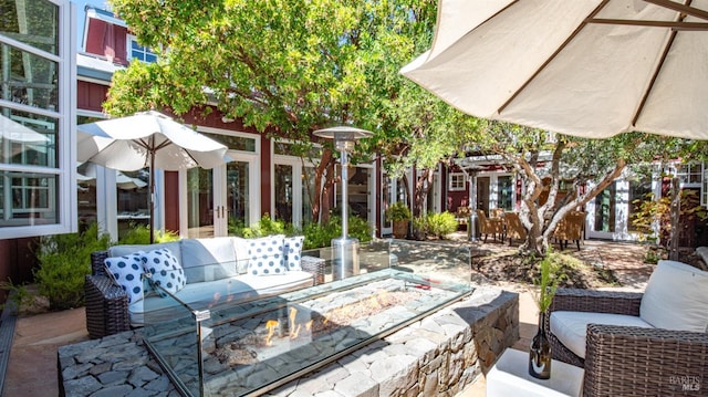 view of patio / terrace featuring an outdoor living space with a fire pit and french doors
