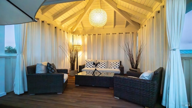 sunroom / solarium featuring beam ceiling and a notable chandelier