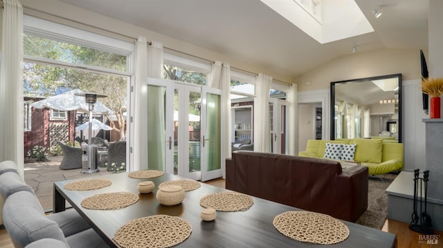 sunroom / solarium featuring plenty of natural light, french doors, and a skylight