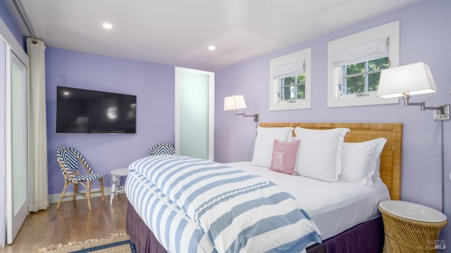 bedroom featuring baseboards, recessed lighting, and wood finished floors