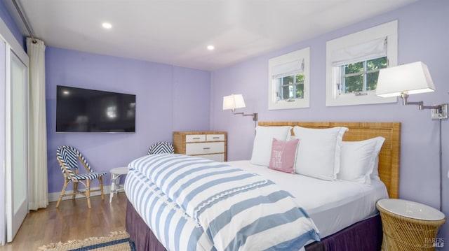 bedroom with wood finished floors and recessed lighting