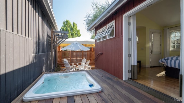 exterior space with a wooden deck and hot tub deck surround