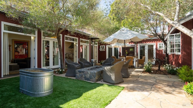 view of patio featuring an outdoor fire pit and french doors