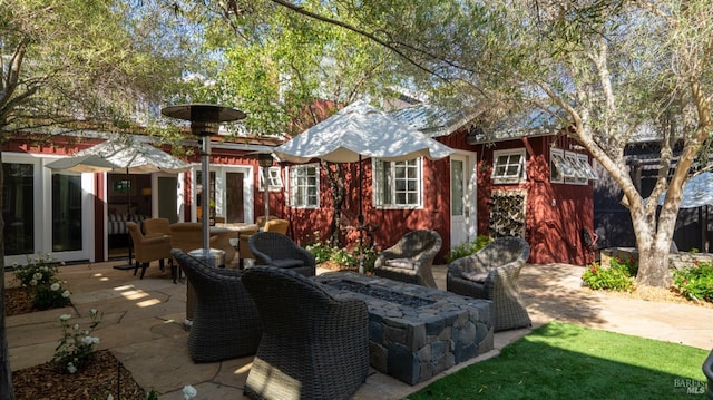 rear view of house with a patio area and a fire pit