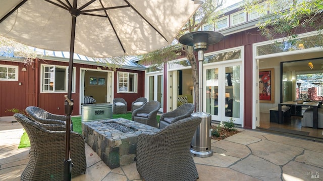 view of patio / terrace featuring an outdoor fire pit and french doors