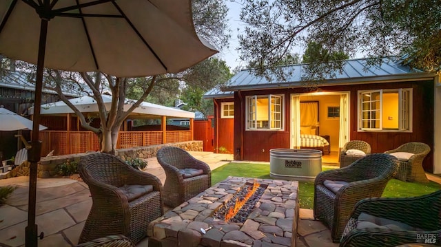 view of patio featuring an outbuilding and fence
