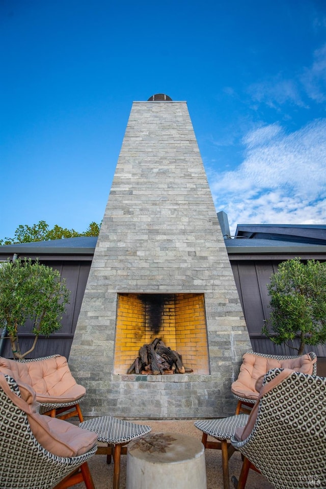 exterior space with stone siding and an outdoor stone fireplace
