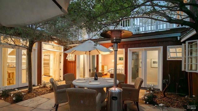 view of patio / terrace featuring a balcony and outdoor dining space