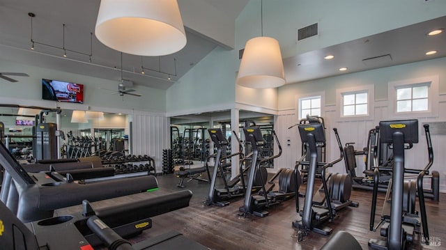 gym with ceiling fan, high vaulted ceiling, and visible vents
