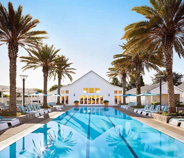 community pool featuring a patio and fence