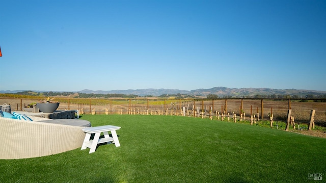 view of yard with a mountain view, a rural view, and fence