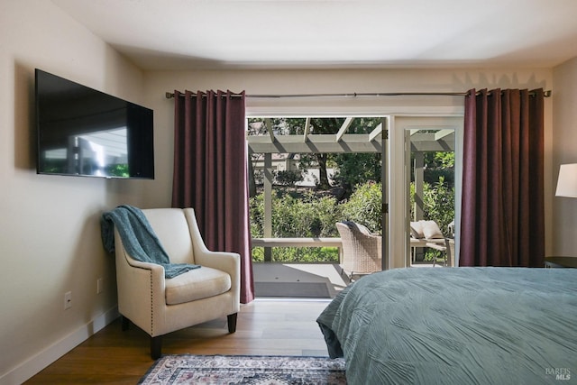 bedroom featuring wood finished floors and baseboards