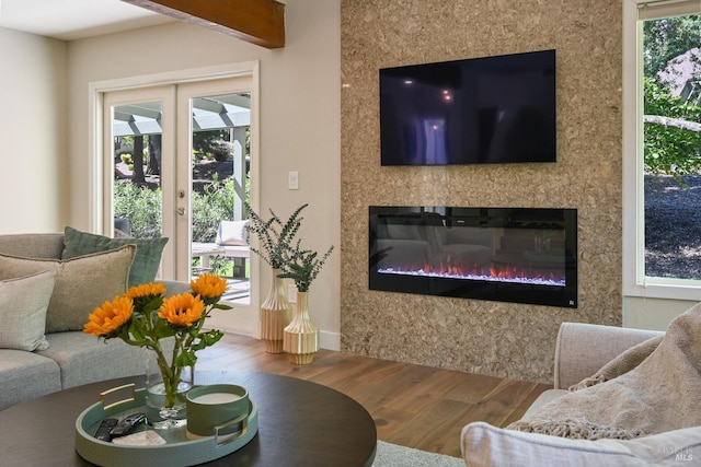 living room featuring a glass covered fireplace and wood finished floors