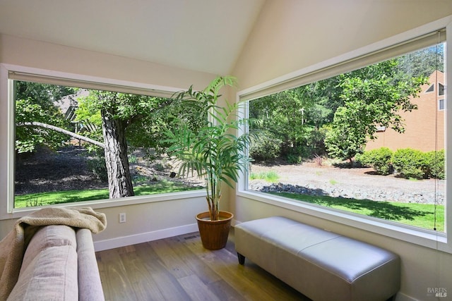 sitting room with vaulted ceiling, baseboards, and wood finished floors