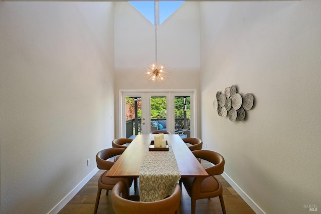 dining room with baseboards, a chandelier, and dark wood-style floors