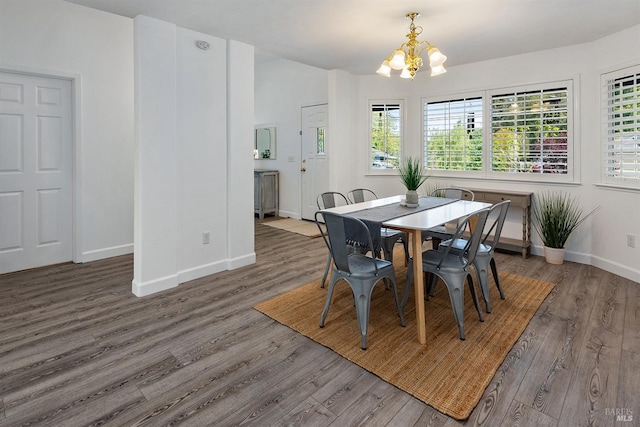 dining space with an inviting chandelier, wood finished floors, and baseboards