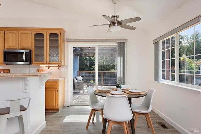 dining area featuring plenty of natural light, visible vents, light wood-style flooring, and ceiling fan