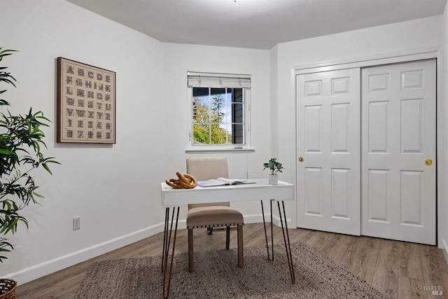 office space featuring wood finished floors and baseboards
