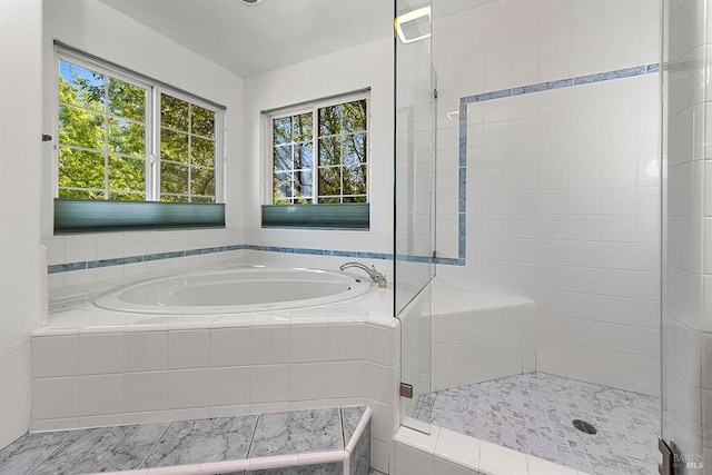 full bathroom featuring a stall shower and a bath