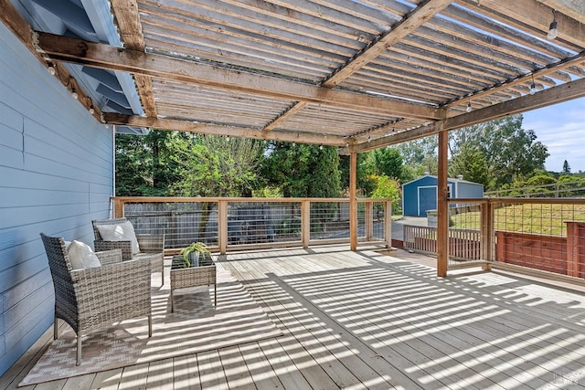 wooden deck with an outbuilding and a storage unit