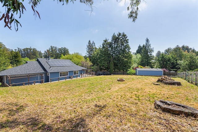 view of yard featuring a fenced backyard and a fire pit