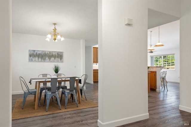 dining room featuring an inviting chandelier, dark wood-type flooring, and baseboards