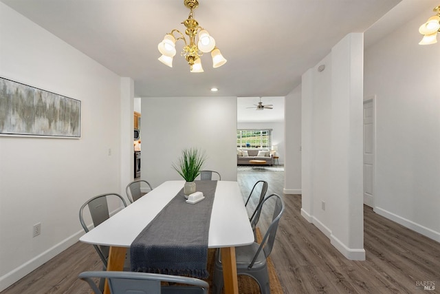 dining space featuring baseboards, recessed lighting, and wood finished floors