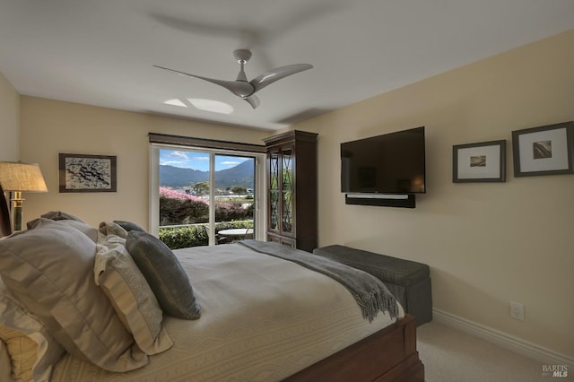 carpeted bedroom featuring baseboards and a ceiling fan