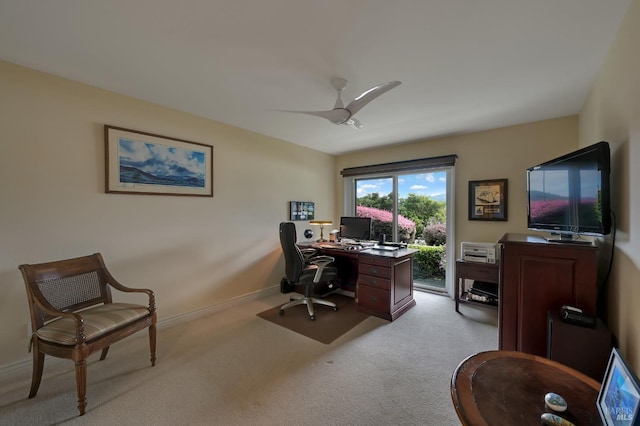 office area featuring light colored carpet, baseboards, and a ceiling fan