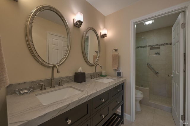 full bathroom with toilet, tile patterned floors, a sink, and a stall shower