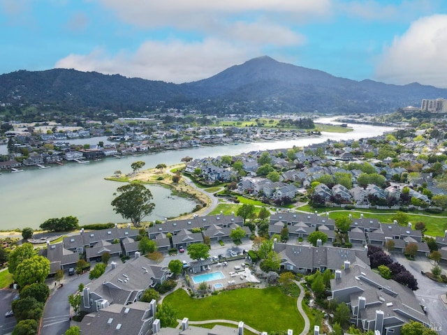 drone / aerial view featuring a water and mountain view and a residential view