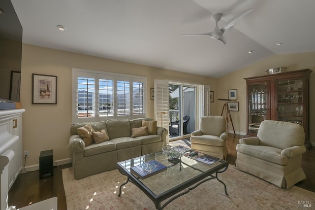 living room with vaulted ceiling, ceiling fan, baseboards, and wood finished floors