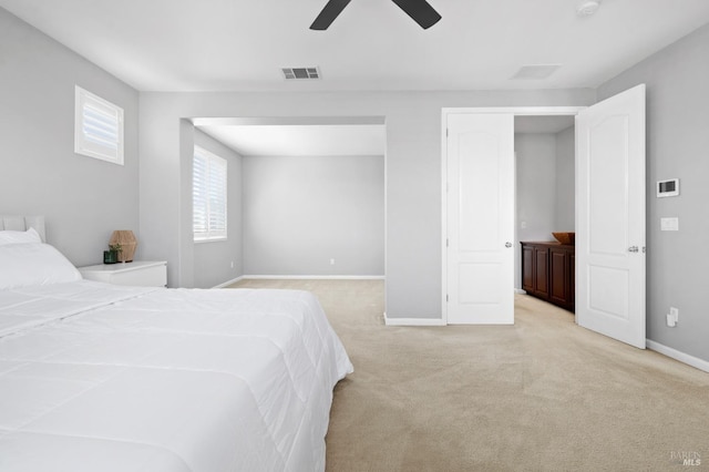 bedroom with light colored carpet, visible vents, baseboards, and a ceiling fan