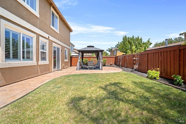 view of yard featuring a patio area, a gazebo, and a fenced backyard