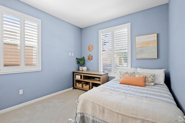 carpeted bedroom with baseboards