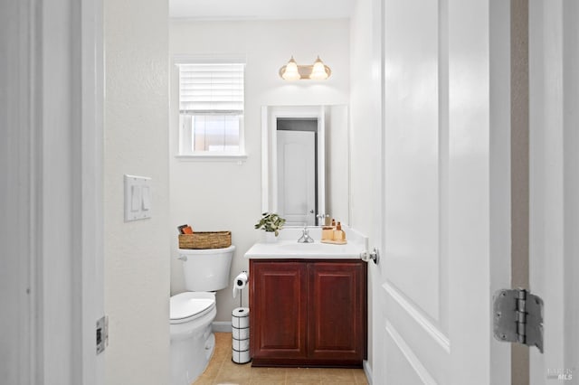 half bath featuring tile patterned flooring, toilet, baseboards, and vanity