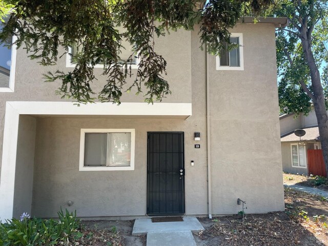 doorway to property with stucco siding