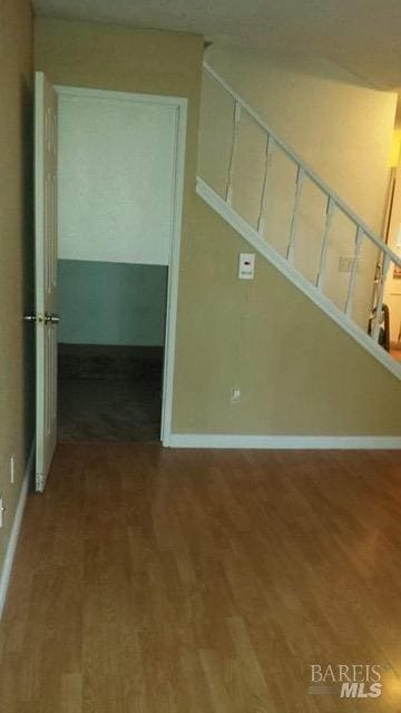 interior space featuring baseboards and wood finished floors