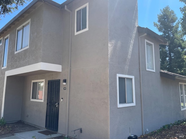 back of property with stucco siding
