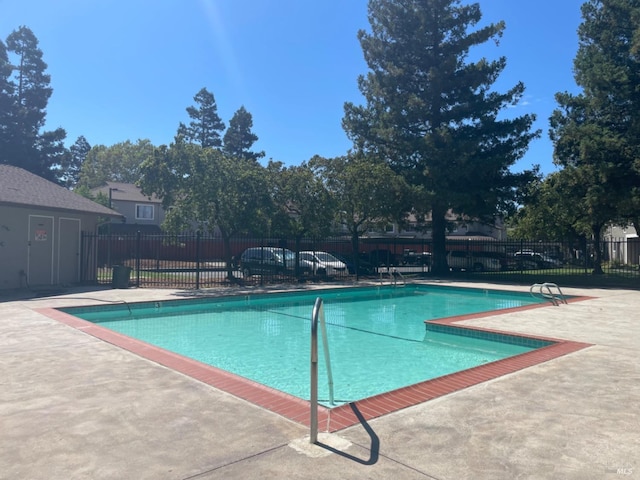 pool featuring a patio and fence